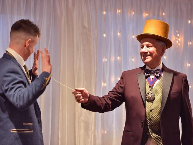 Magician performs a magic trick at a wedding